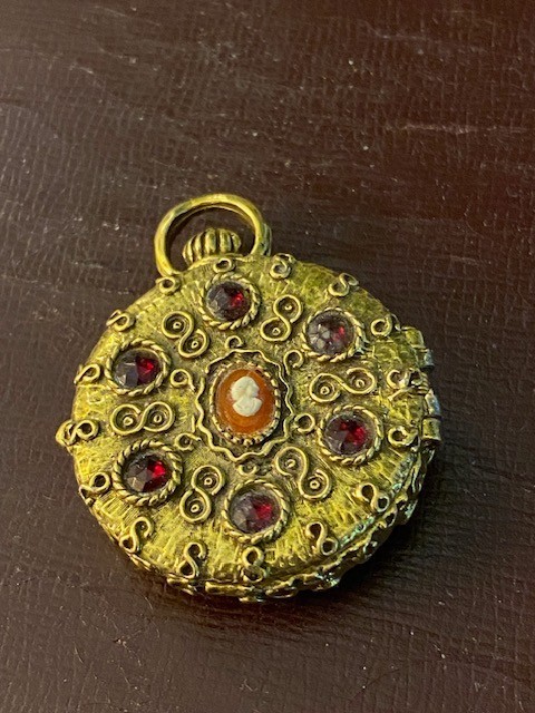 Vintage locket pendant featuring hinged design holding solid (used) perfume